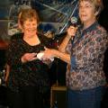 Shirley May presented with 21st birthday plaque by treasurer Bev Sharpe/PHOTO  